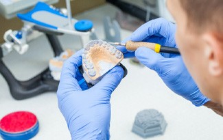 Lab technician carving dentures 