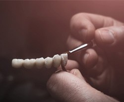 Lab technician painting dentures 