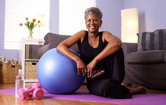 Smiling older woman on exercise mat