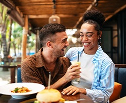 Couple smiling while enjoying meal at restaurant