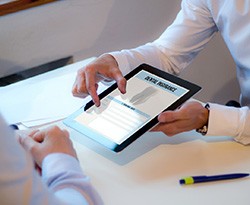 Patient reviewing dental insurance form on tablet