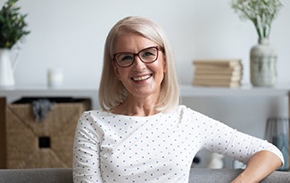Woman in glasses and white shirt smiling