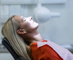 Woman with blonde hair relaxed in the dental chair