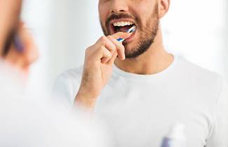 man brushing teeth