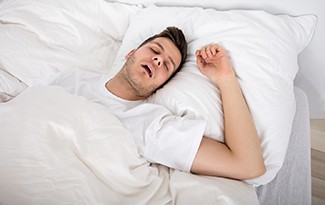 Man with sleep apnea in Lincoln, NE snoring in bed