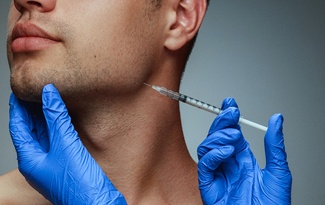 a person receiving a dermal filler injection in their jaw