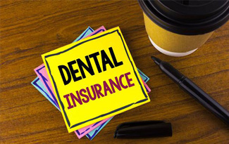 Dental insurance written on yellow note paper