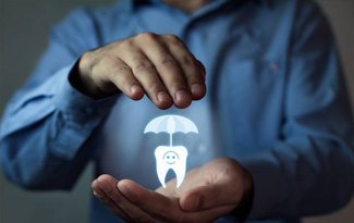 Man holding animated tooth under an umbrella