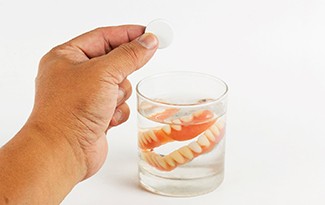 Dentures soaking in solution