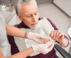 Man with dentures in dental chair