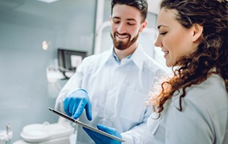 a dentist showing his patient her dental information