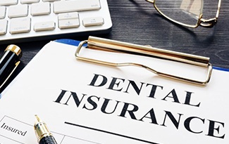 a dental insurance form next to a keyboard