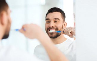 man brushing his teeth