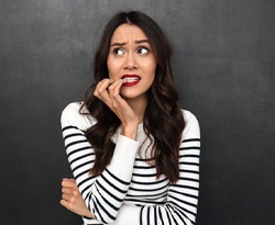 woman nervously biting her fingernails