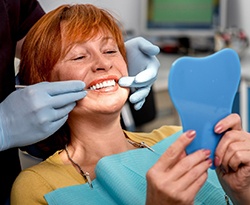 patient smiling after getting dental implants in Lincoln