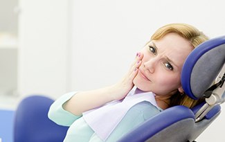 Female dental patient with failed dental implant in Lincoln, NE