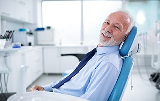 Bearded dental patient leaning back in dental chair