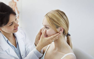 Dentist examining patients facial structure