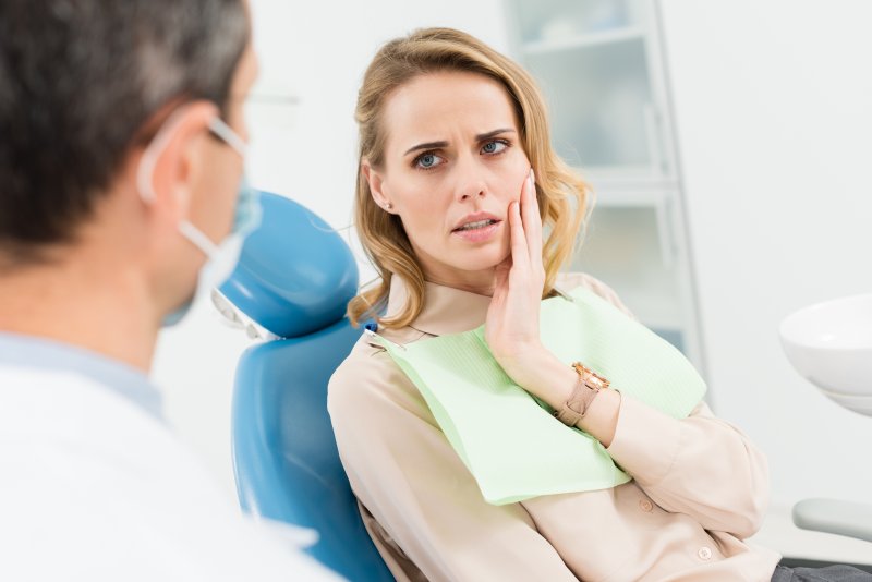 Patient with tooth pain talking to dentist