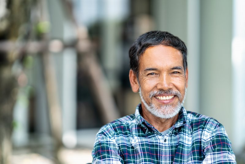 Man smiling with dental implant