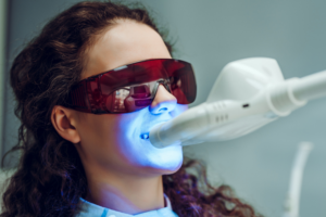 Female patient having teeth whitening treatment