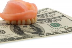 Dentures on top of some cash money